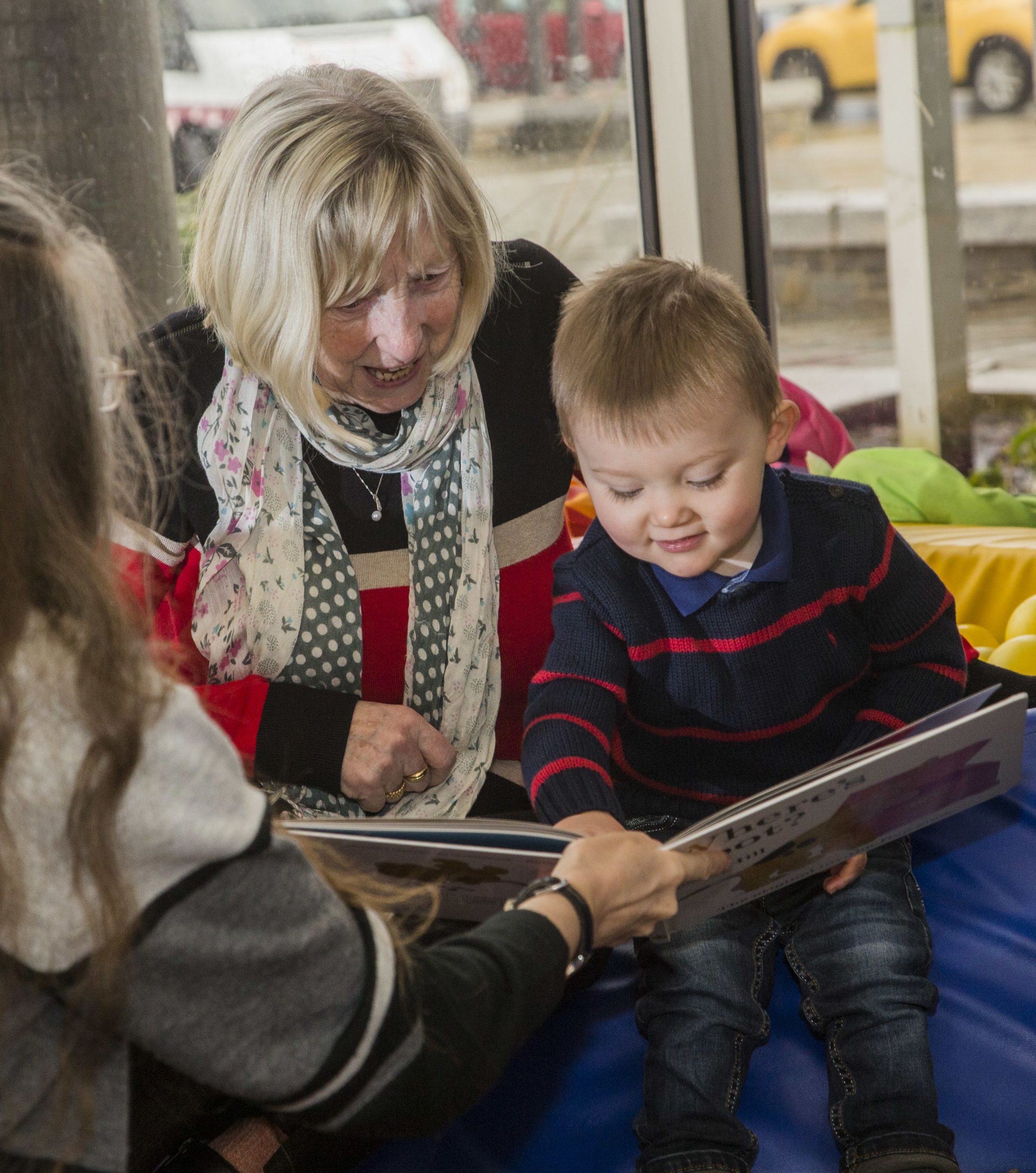 Adult and younger child reading picture books at Aberdare Library