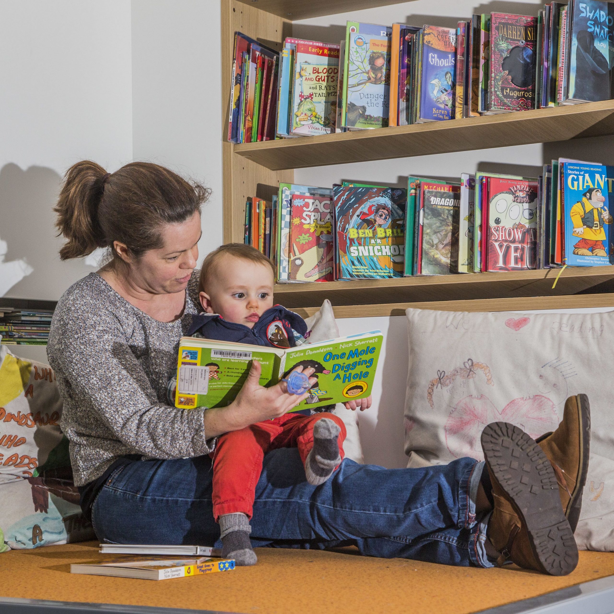 Mother and baby reading a book at Bridgend Libraries
