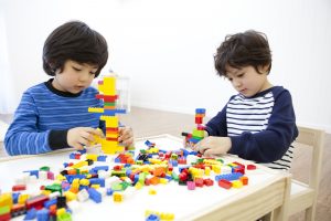 Two boys playing lego