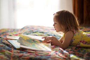 Girl in yellow dress reading a book