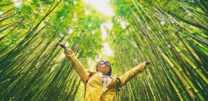 Girl with Open Arms surrounded by Bamboo