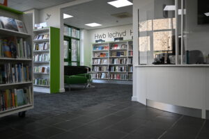 Health Hub bookshelves and reception area in Llanrwst Library
