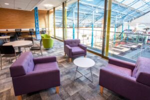 Abergavenny Library new library relaxed area with purple chairs overlooking the town hall atrium