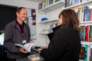 Library user borrowing books on a mobile service